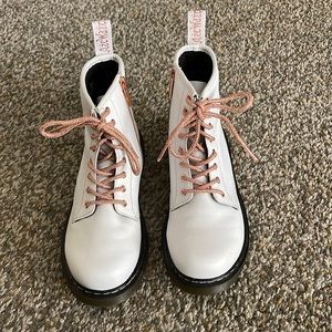 Girls White Dr Martens combat boots with rose gold laces and side zippers.